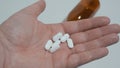 White pills in palm of hand. Medicine for pain relief. Royalty Free Stock Photo