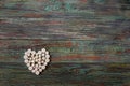 White pills in the shape of a heart on a wooden background Royalty Free Stock Photo