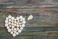 White pills in the shape of a heart on a wooden background Royalty Free Stock Photo