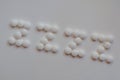 White pills spelling out ZZZZ on white background .concept insomnia ,Melatonin to help sleep