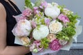 White pink big bouquet with peonies, carnation and roses in woman hands Royalty Free Stock Photo