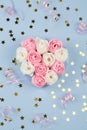 White and pink candy in form of roses in box , pink ribbon and small stars on blue background Royalty Free Stock Photo