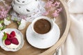 White and pink flowers. Breakfast in bed. Flavored coffee. Delicate light colors. Romance. Place for text.