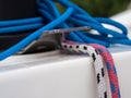 White and pink lines and blue tangle on sailing boat