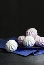 White and pink marshmallow on blue plate on black background Royalty Free Stock Photo