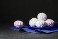 White and pink marshmallow on blue plate on black background Royalty Free Stock Photo