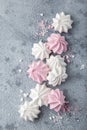 White and pink meringues on grey background