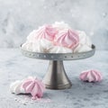White and pink meringues on cake stand