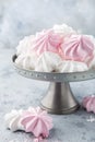 White and pink meringues on cake stand