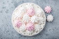 White and pink meringues on white plate