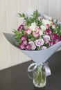 The bouquet of white and pink spray roses in gray floral paper Royalty Free Stock Photo