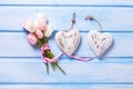 White and pink spring tulips and two decorative hearts on blue Royalty Free Stock Photo