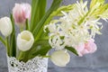 White and pink tulips and hyacinths in a white vase