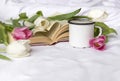 White and pink tulips, mug on white sheet, open book Royalty Free Stock Photo