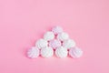 White and pink twisted meringues in a shape of pyramid on pink background, greeting card, copy space Royalty Free Stock Photo