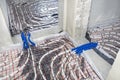 White pipes of underfloor heating systems, arranged in an individual family home on an insulating foil, passing through the founda Royalty Free Stock Photo