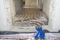White pipes of underfloor heating systems, arranged in an individual family home on an insulating foil, passing through the founda Royalty Free Stock Photo