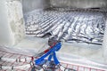 White pipes of underfloor heating systems, arranged in an individual family home on an insulating foil, passing through the founda Royalty Free Stock Photo