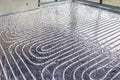 White pipes of underfloor heating systems, distributed in an individual family house on insulating foil. Royalty Free Stock Photo