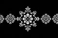 White pixel art snowflakes creating a seamless horizontal christmas border on a black background Royalty Free Stock Photo