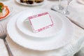 White place card decorated on a plate