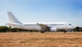 A white plane on the airport runway is taxiing. Takeoff and landing. Arrival and departure. Place for text. Passenger Royalty Free Stock Photo