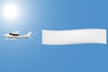 White plane with a banner in the sky Royalty Free Stock Photo