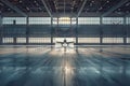 A white plane is sitting in a large hangar Royalty Free Stock Photo