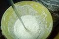 White plaster in a bucket of water. Preparation of mixture for finishing walls and ceilings in the apartment. Repair in