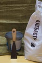 White plastic bag of alabaster 5 kilograms, plastic bucket with