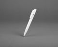 White plastic ballpoint pen on a grey backgroundÃÅ½ Royalty Free Stock Photo