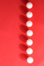 White plastic balls on a red background Royalty Free Stock Photo