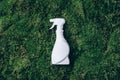 White plastic bottle of cleaning product, household chemicals or liquid laundry detergent on green grass, moss Royalty Free Stock Photo