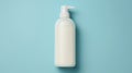 White plastic bottle with dispenser on a blue background. Concept medicine, hygiene, cosmetics, perfumery