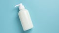 White plastic bottle with dispenser on a blue background. Concept medicine, hygiene, cosmetics, perfumery