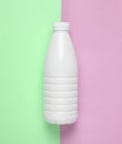 White plastic bottle of yogurt on a blue pink pastel background, minimalism, top view. Royalty Free Stock Photo
