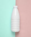 White plastic bottle of yogurt on a blue pink pastel background, minimalism, top view. Royalty Free Stock Photo