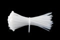 White plastic cable ties isolated on black background. plastic wire ties close up Royalty Free Stock Photo