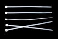 White plastic cable ties isolated on black background. plastic wire ties close up Royalty Free Stock Photo