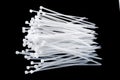 White plastic cable ties isolated on black background. plastic wire ties close up Royalty Free Stock Photo