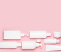 White plastic cans on a pink background. Cosmetics for skin care. Means for washing, disinfecting and washing