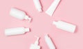 White plastic cans on a pink background. Cosmetics for skin care. Means for washing, disinfecting and washing