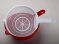 White plastic colander in red bowl Royalty Free Stock Photo