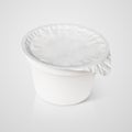 White plastic container with foil lid on gray Royalty Free Stock Photo