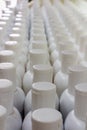 White plastic cream bottles in rows.