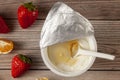 A white plastic cup of plain greek yogurt with a peeled off aluminum foil seal and a disposable plastic spoon Royalty Free Stock Photo