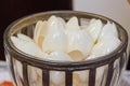 White plastic disposable spoons in a round vase