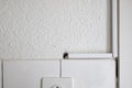 White plastic electric cable duct covers on a kitchen wall. Close up shot, no people Royalty Free Stock Photo