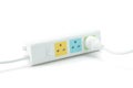 White plastic electrical multiple sockets with connected plugs on a white background. Royalty Free Stock Photo