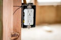 White plastic electrical outlet mounted in a box and a wood stud Royalty Free Stock Photo